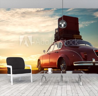 Picture of Retro red car with luggage on roof rack at sunset Travel vacation concepts